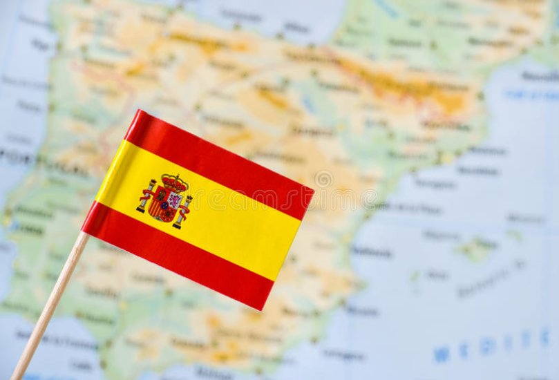 spain-flag-paper-pin-blurry-map-background-61305241